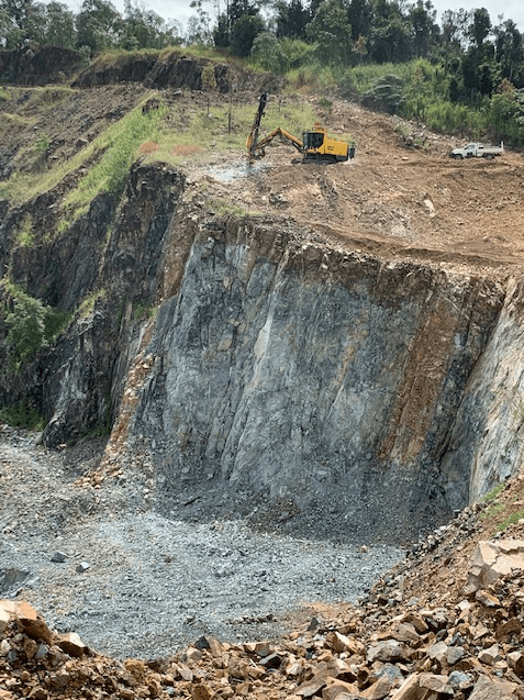 A yellow Atlas Copco Drill rig performing quarry drill and blast services in Mackay Queensland. 